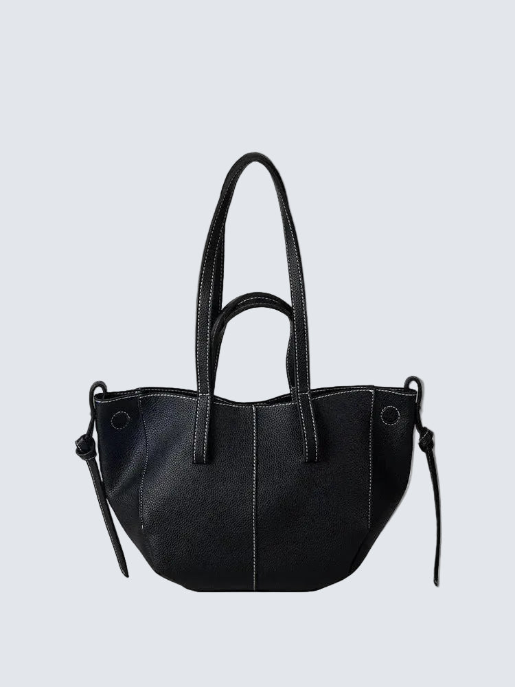 Black mini leather tote bag with structured silhouette and top handles, photographed on a white background.