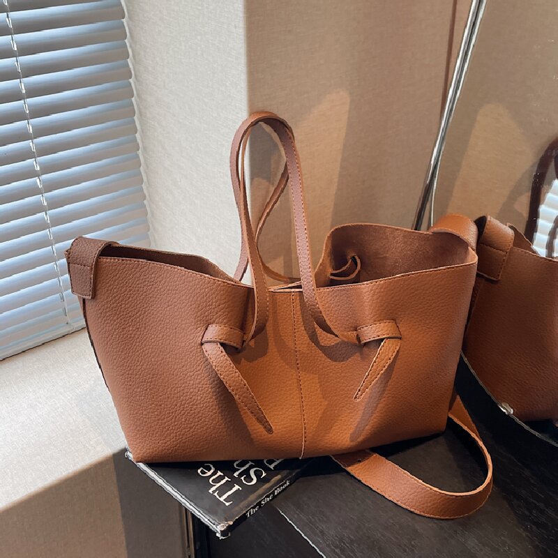 Soft Minimal Crossbody Bag in brown PU leather with refined stitching and clean design on a table.