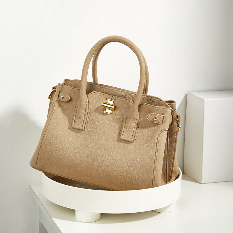 Khaki medium top handle bag with structured silhouette and gold lock detail