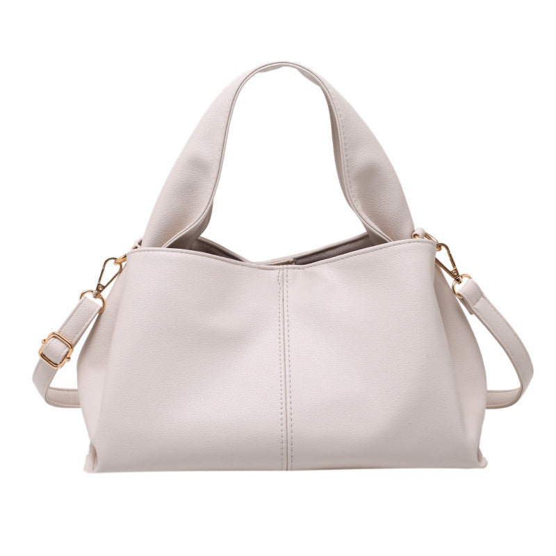 Medium Everyday Shoulder Bag in light gray faux leather with structured design and adjustable strap.