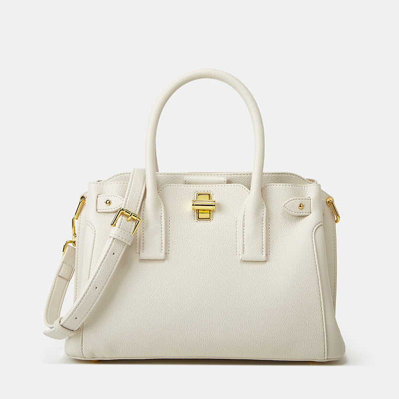 White structured medium top handle bag with elegant gold-tone closure